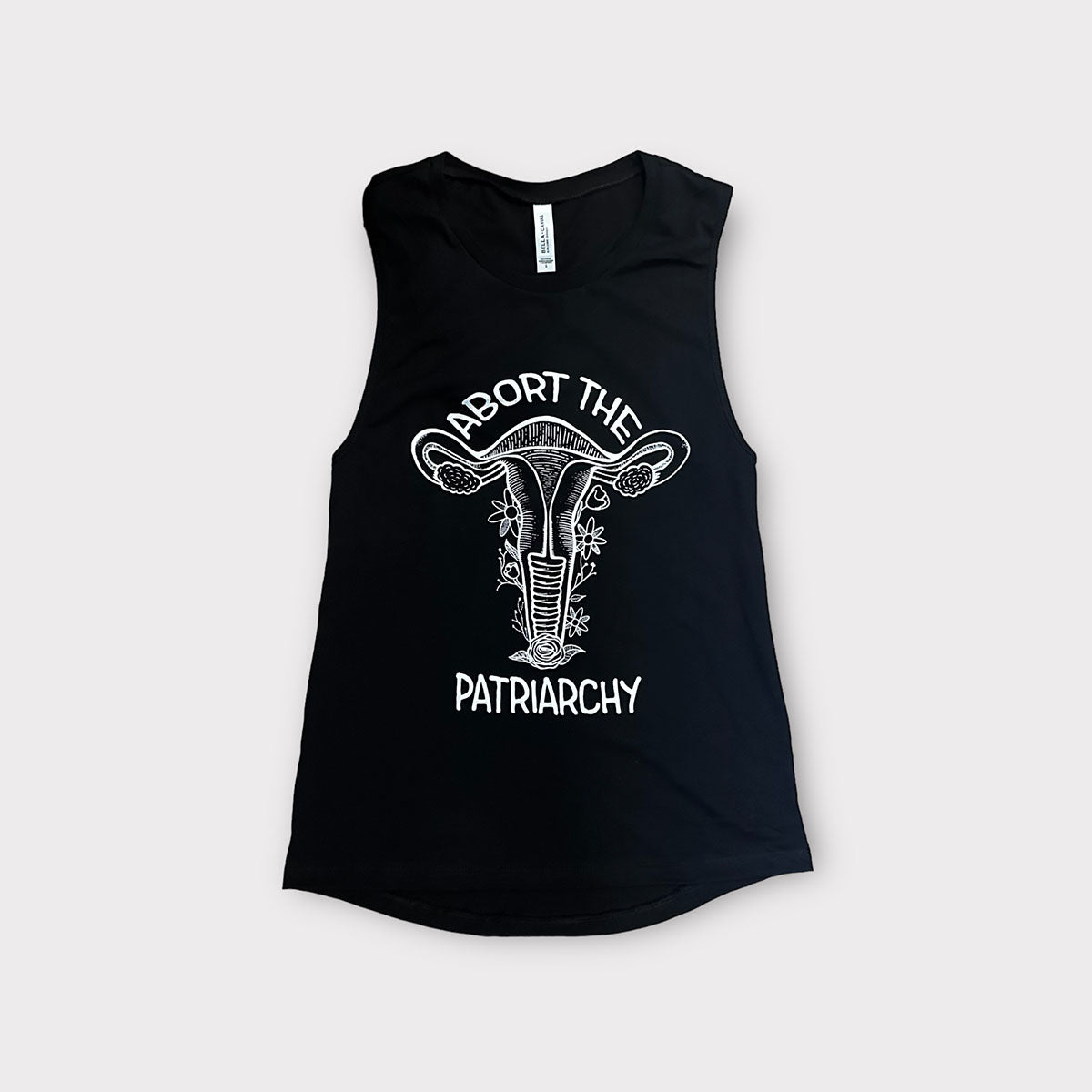 black muscle tank top with a white screen printed floral uterus graphic and "abort the patriarchy" text
