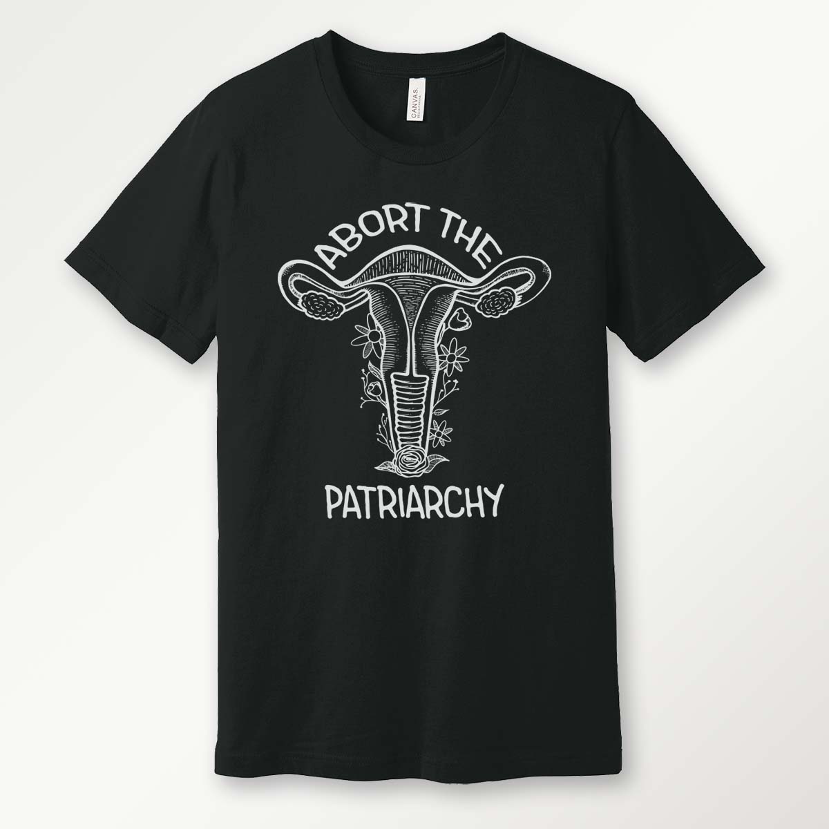 black t-shirt with a white screen printed floral uterus graphic and "abort the patriarchy" text