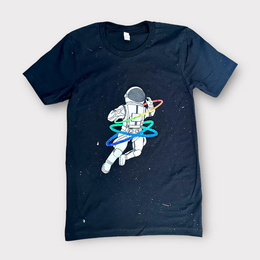 vintage black t-shirt speckled with paint featuring a rainbow gay astronaut graphic